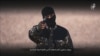 A masked militants points a weapon as he speaks in this still image from an IS video obtained on January 4a social media website which has not been independently verified.
