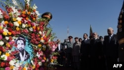 Afghanistan -- Afghan Chief Executive Officer Abdullah Abdullah (2R) watches as a soldier carries a wreath with a photo of slain Afghan national hero Ahmad Shah Massud during an event marking the fifteen anniversary of Massud's death in Kabul, September 8