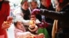 People buy plush toys in Shanghai to mark the upcoming Year of the Snake. It's unlikely that many in Russia will be following suit.