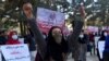 Afghan Solidarity members hold posters and chant slogans as they stage a protest against the stoning of Rukhshana in the capital Kabul in November.