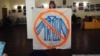 Russian artist Yelizaveta Savolainen with the banner she used to protest against a lecture by a pro-Kremlin activist at the Russian State University for the Humanities. 