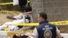 A forensics expert surveys the bloody scene outside the U.S. consulate