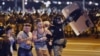 Riot police detain a group of demonstrators during a protest after polls closed in Belarus's presidential election in Minsk on August 9, 2020. 