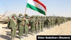 Members of Tajikistan's armed forces line up during joint military drills involving Russia, Uzbekistan, and Tajikistan at the Harb-Maidon training ground near the border with Afghanistan on August 10.
