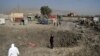Afghan security personnel stand alert at the site after a powerful truck bomb targeting a hotel used by foreign contractors exploded on the outskirts of Kabul on August 1.